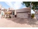 Elegant home showcasing a private two-car garage and beautiful brick-paved driveway at 6202 E Mckellips Rd # 210, Mesa, AZ 85215