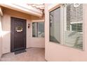 Inviting entryway with a decorative door, charming wreath, and well-lit porch area at 6202 E Mckellips Rd # 210, Mesa, AZ 85215