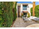 Welcoming patio with comfortable outdoor seating, mature landscaping, and architectural details at 7242 E Joshua Tree Ln, Scottsdale, AZ 85250