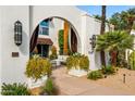 Charming exterior view with covered patio, beautiful landscape, and comfortable seating area at 7242 E Joshua Tree Ln, Scottsdale, AZ 85250