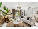 Living room boasts sliding glass doors, a modern screen wall, and stylish furnishings at 7242 E Joshua Tree Ln, Scottsdale, AZ 85250