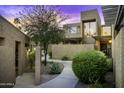 Inviting home exterior featuring desert landscaping and a modern stucco design at sunset at 7401 N Scottsdale Rd # 24, Paradise Valley, AZ 85253