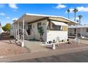 Charming home featuring a covered porch, landscaped yard, and delightful curb appeal at 7807 E Main St # Aa-8, Mesa, AZ 85207
