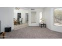 Open living room with tile floors, a large wall mirror and dining room access at 7841 N 18Th St, Phoenix, AZ 85020