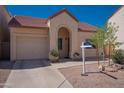 Welcoming single-Gathering home featuring a garage, desert landscaping, and inviting entrance at 1027 W Julie Dr, Tempe, AZ 85283