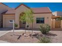 Inviting single-level home with desert landscaping and charming arched entryway at 1027 W Julie Dr, Tempe, AZ 85283
