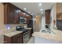 Beautiful kitchen with dark cabinets, granite countertops, and stainless steel appliances at 1027 W Julie Dr, Tempe, AZ 85283
