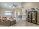 Open-concept living room featuring high ceilings, a ceiling fan, and tile flooring at 1027 W Julie Dr, Tempe, AZ 85283