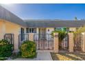 Single level home featuring desert landscaping and a gated front entry at 10521 W Roundelay Cir, Sun City, AZ 85351