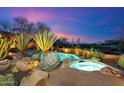 Backyard pool and spa area with desert landscaping, offering a relaxing retreat with scenic views at 10639 E Mark Ln, Scottsdale, AZ 85262