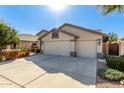 Spacious three-car garage and large driveway offer ample parking at this charming single-story home at 13825 W Montebello Ave, Litchfield Park, AZ 85340