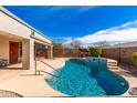 Backyard boasts a sparkling pool and spa, perfect for outdoor relaxation and entertaining in a private setting at 13825 W Montebello Ave, Litchfield Park, AZ 85340