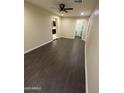 Inviting living room featuring sleek wood flooring, neutral paint, and a ceiling fan for added comfort at 1533 W 7Th St, Tempe, AZ 85281