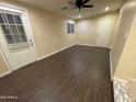 Open floor plan with neutral paint, wood floors, and a door that leads to the backyard at 1533 W 7Th St, Tempe, AZ 85281