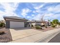 Charming single-story home featuring a well-manicured desert landscape, neutral tones, and a two car garage at 15655 W Bethesda Ct, Surprise, AZ 85374