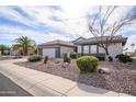 Charming single-story home featuring a well-manicured desert landscape, neutral tones, and a two car garage at 15655 W Bethesda Ct, Surprise, AZ 85374
