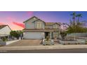 Stunning two-story home with a well-manicured front yard and a brick driveway at 16011 N 15Th Pl, Phoenix, AZ 85022