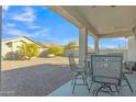 Spacious backyard featuring a covered patio, low-maintenance landscaping, and mature trees at 18230 E El Viejo Desierto --, Gold Canyon, AZ 85118