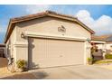 Spacious two-car garage with a light-colored door and well-maintained landscaping at 1942 E Connemara Dr, San Tan Valley, AZ 85140