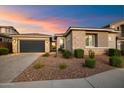 Modern home with a two-car garage and desert landscaping, offering curb appeal and low maintenance at 22421 N 34Th St, Phoenix, AZ 85050