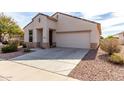 Charming single-story home with a two-car garage and low-maintenance desert landscaping at 22565 W La Pasada Blvd, Buckeye, AZ 85326