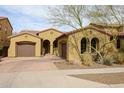 Charming single-story home with a terracotta tile roof, dual garages, and well maintained landscaping at 2320 E Allen St, Phoenix, AZ 85042