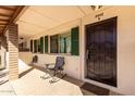 Covered front porch featuring seating area and secure front door entry at 2442 E University Dr # 6, Mesa, AZ 85213