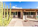 Inviting front porch featuring desert landscaping, seating and secure front door entry at 2442 E University Dr # 6, Mesa, AZ 85213