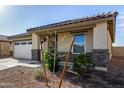 Attractive single-story home with desert landscaping and a two car garage at 24531 W Cocopah St, Buckeye, AZ 85326