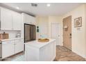 Bright kitchen boasts a center island, stainless steel appliances, and white cabinetry at 2511 W Queen Creek Rd # 163, Chandler, AZ 85248