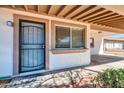 Covered front entry featuring a secure screen door and a welcoming exterior at 2744 E John Cabot Rd, Phoenix, AZ 85032