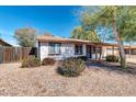 Inviting front exterior with desert landscaping and partial shade from mature trees at 2744 E John Cabot Rd, Phoenix, AZ 85032