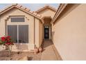 Inviting front entrance with an decorative security door, desert landscaping, and potted plants at 316 W Kelton Ln, Phoenix, AZ 85023