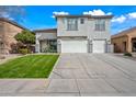 Charming two-story home featuring a well-manicured lawn and a spacious three-car garage at 40975 N Arbor Ave, San Tan Valley, AZ 85140