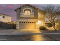 Charming two-story house with landscaped yard and garage on a street with a pink sky at 4285 S Celebration Dr, Gold Canyon, AZ 85118