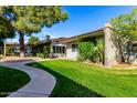 Well-maintained home featuring lush landscaping, grassy lawn, and charming curb appeal at 4800 N 68Th St # 385, Scottsdale, AZ 85251