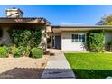 Charming home with inviting walkway, lush landscaping, and a well-manicured front yard at 4800 N 68Th St # 385, Scottsdale, AZ 85251