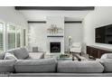Bright living room with brick fireplace, gray sofa and lots of natural light from the windows at 4800 N 68Th St # 385, Scottsdale, AZ 85251