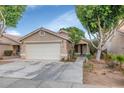 Charming single-story home with a spacious two-car garage and desert landscaping at 5002 W Wikieup Ln, Glendale, AZ 85308