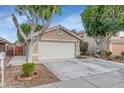 Charming single-story home with a spacious two-car garage and desert landscaping at 5002 W Wikieup Ln, Glendale, AZ 85308