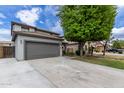 Charming two-story home with a well-maintained front yard and a gray two-car garage at 504 E Quentin Ln, San Tan Valley, AZ 85140