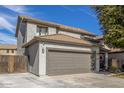 Attractive two-story home with a gray concrete driveway and tile roof at 504 E Quentin Ln, San Tan Valley, AZ 85140