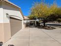 Long driveway leading to a two-car garage with mature landscaping around the home at 6016 W Gambit Trl, Phoenix, AZ 85083