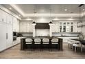 Elegant kitchen features custom cabinets, marble backsplash, large island with seating, and modern stainless appliances at 6500 E Cactus Wren Rd, Paradise Valley, AZ 85253