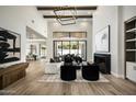 Bright living room boasts high ceilings, wood floors, fireplace, and large windows overlooking a lush backyard at 6500 E Cactus Wren Rd, Paradise Valley, AZ 85253
