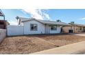 Attractive one-story home featuring a convenient carport and simple landscaping at 6817 W Palm Ln, Phoenix, AZ 85035