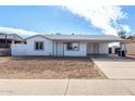 Charming single-story home featuring a covered carport and low-maintenance front yard at 6817 W Palm Ln, Phoenix, AZ 85035