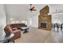 Spacious living room with a stone fireplace, carpet flooring, and lots of natural light at 7102 W Julie Dr, Glendale, AZ 85308