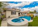 Backyard pool and hot tub create a backyard oasis for relaxation and entertainment at 714 W Desert Hills Dr, San Tan Valley, AZ 85143