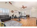 Spacious bonus room featuring high ceilings, hardwood floors, and ceiling fans at 8335 W Berridge Ln, Glendale, AZ 85305